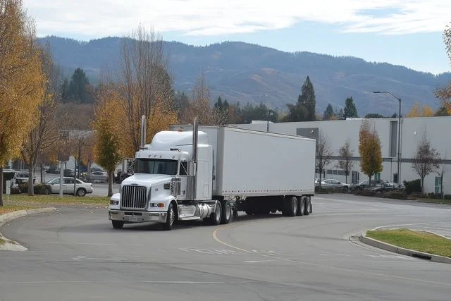 Photo of a standard dry van trailer on a highway, illustrating its enclosed design and versatility for freight transport.