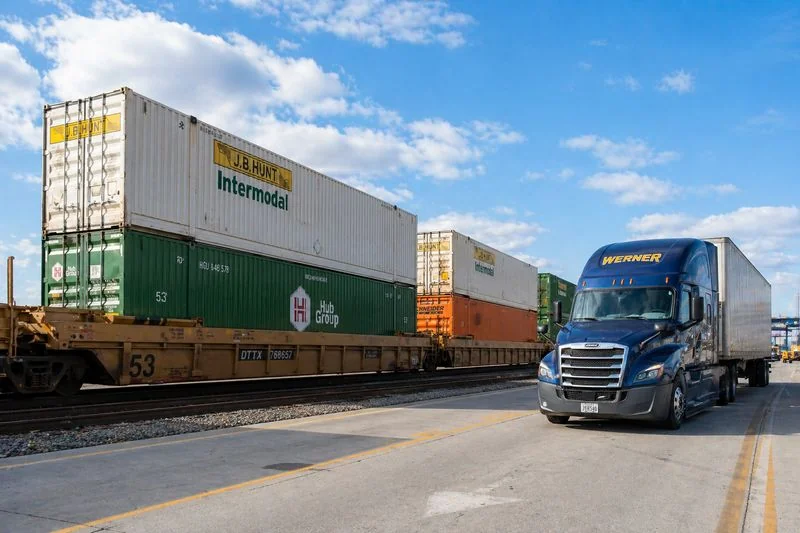 Intermodal freight transport with train and truck carrying shipping containers