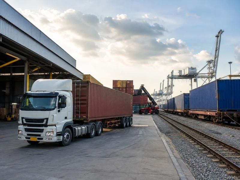 Freight truck moving cargo through an intermodal supply chain transportation facility