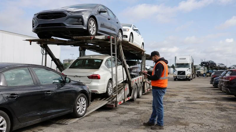 Vehicle logistics coordinator managing car shipping and transporter scheduling